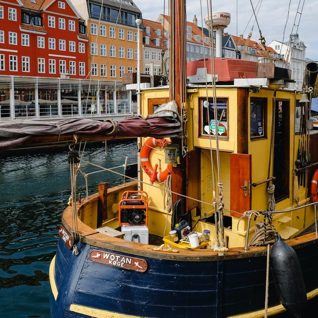 yellow-and-blue-boat-floating-in-a-canal-2563683